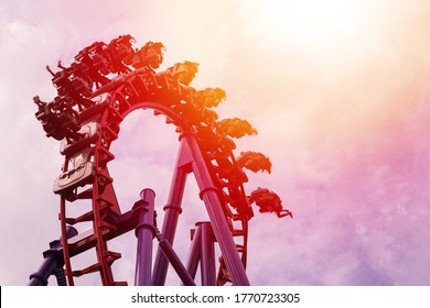 Roller coaster in the amusement park with the sunset background.