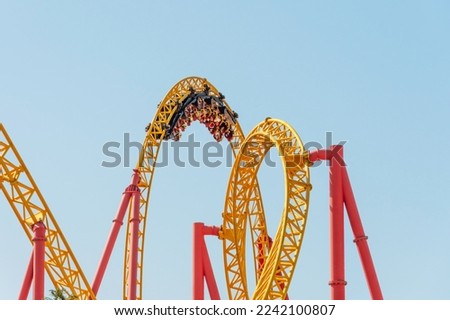 Roller coaster up down turn and a passing loop feint, spiral train of trolleys tends to go down
