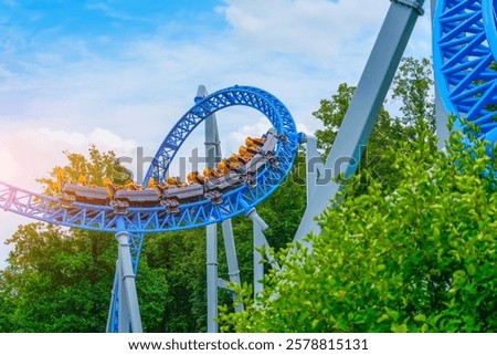 Roller coaster up down turn and a passing loop feint, spiral train of trolleys tends to go down