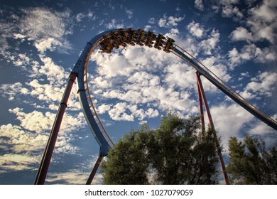 Roller coaster loop with a background of beautiful cloudy sky