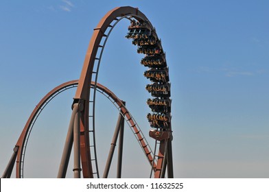 Roller coaster with loops against a blue sky