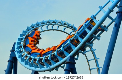  Roller coaster  ride filled  with thrill seekers doing loop.