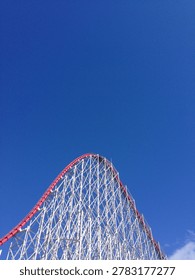 Roller Coaster Structure Against Clear Blue Sky
