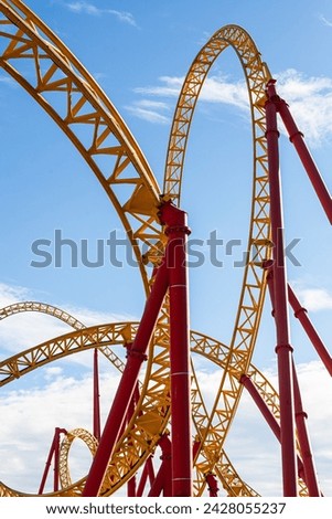 Roller coaster with twists, turns, cave, loops in amusement park
