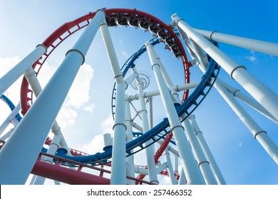 a roller coaster's loop with blue sky - Shutterstock ID 257466352