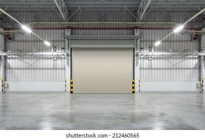 Roller Door Or Roller Shutter Using For Factory, Warehouse Or Hangar. Industrial Building Interior Consist Of Polished Concrete Floor And Closed Door For Product Display Or Industry Background.