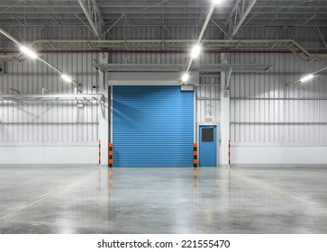 Roller Door Or Roller Shutter Using For Factory, Warehouse Or Hangar. Industrial Building Interior Consist Of Polished Concrete Floor And Closed Door For Product Display Or Industry Background.