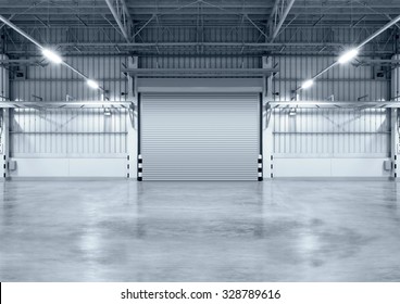 Roller Door Or Roller Shutter Using For Factory, Warehouse Or Hangar. Industrial Building Interior Consist Of Polished Concrete Floor And Closed Door For Product Display Or Industry Background.