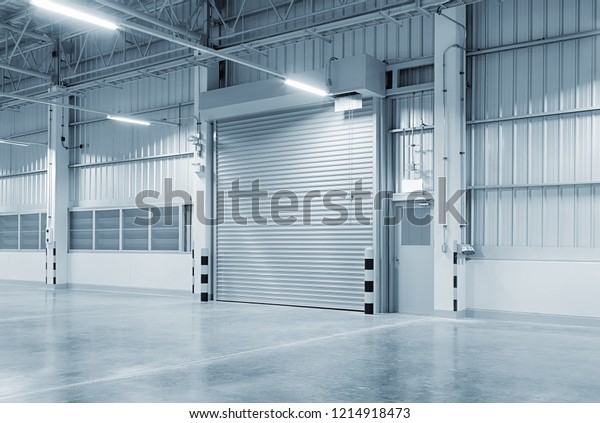 Roller door or roller shutter using for\
factory, warehouse or hangar. Industrial building interior consist\
of polished concrete floor and closed door for product display or\
industry background.