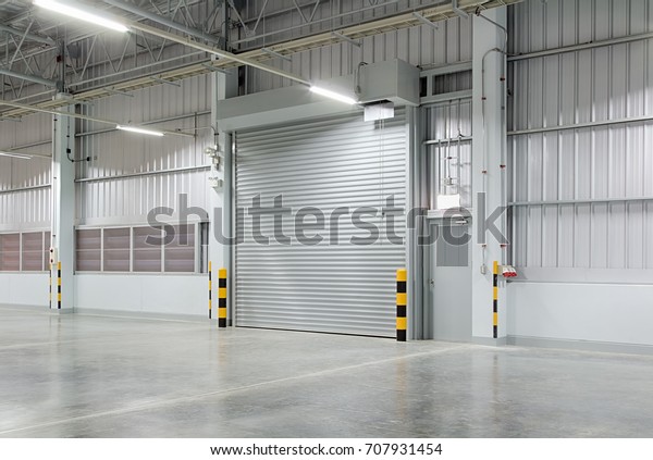 Roller door or roller shutter using for\
factory, warehouse or hangar. Industrial building interior consist\
of polished concrete floor and closed door for product display or\
industry background.