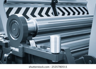 Roller feed unit of continuously high speed metal sheet strip shape beam roll forming machine for manufacturing process in industrial. industry metal processing concept blue tone background - Powered by Shutterstock - Get 15% off with code: PIKWIZARD15