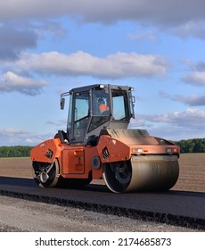 Roller Laying Fresh Asphalt . Road Works With Excavators. Construction Of New Roads On The Highway In The Field 