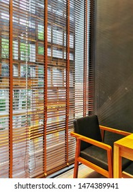 Roller shutter or blinds at the glass window and made of wood.