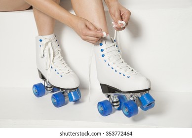 Roller Skater Tying Laces On Her Quad Wheel Boots