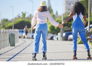 Rollerblading, holding hands and girl friends back on outdoor promenade with balance and skating. Woman, skate and friendship of women on summer holiday break doing a rollerskate activity on pavement