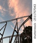 Rollercoaster tracks in sunset sky