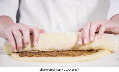 Rolling Dough With A French Rolling Pin To Bake Cinnamon Rolls.