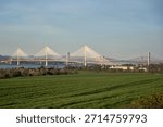 Rolling fields meet the iconic Forth Bridges across the estuary. A quiet Scottish landscape where rural calm meets engineering grandeur.