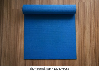 Rolling Or Folding Blue Yoga Mat After A Workout,Exercise Equipment
Healthy Fitness And Sport Concept,Top View And Copy Space For Text