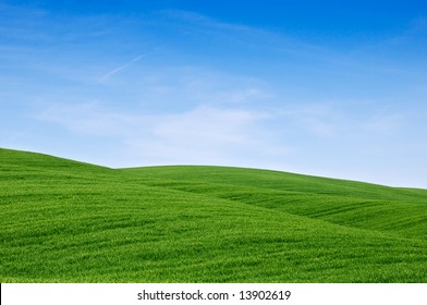 Rolling Green Hills And A Blue Sky