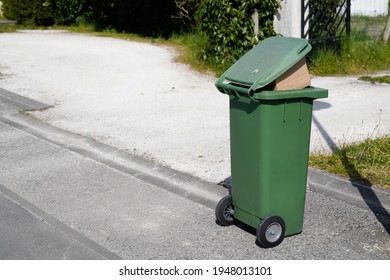 Rolling Green Trash Can Overflowing Bag Wheelie In Street Road City