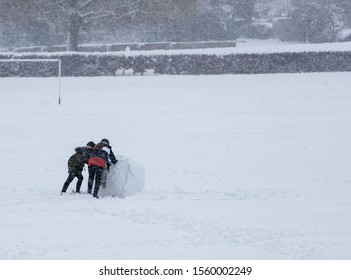 Rolling A Huge Snowball In A Field