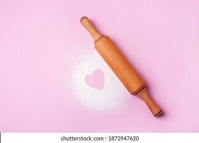 Rolling pin for baking and flour with heart on a pink background. Concept cook with love. Valentine's day baked goods - Powered by Shutterstock