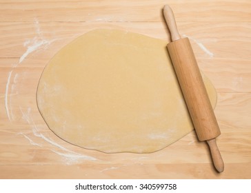 Rolling Pin And Dough On Wooden Background