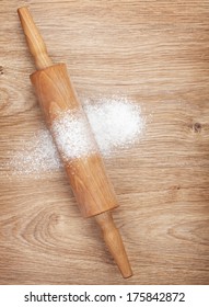 Rolling Pin With Flour On Wooden Table. View From Above