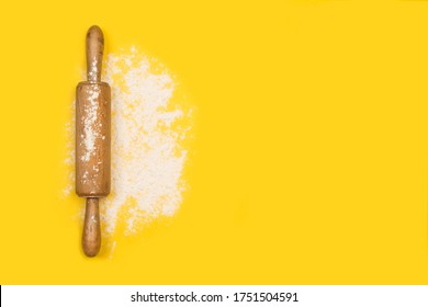 Rolling Pin With Flour On A Yellow Background In A Top View