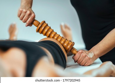 Rolling Pin Madero Therapy Massage. Female Masseuse Performing Cellulite Reduction Treatment 