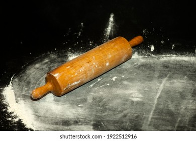 Rolling Pin And White Flour On A Dark Background