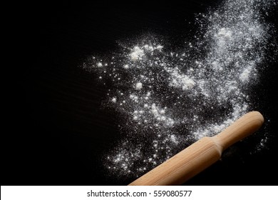 Rolling Pin And White Flour On A Dark Background