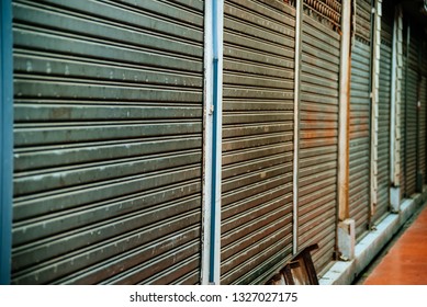 Rolling Steel Door In Thailand Street  Market, Grungy Weathered Metallic Roll Up Door, Gate Is Close In Plaza