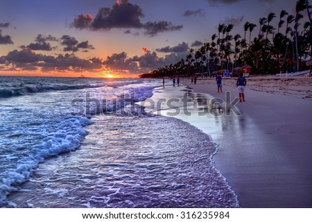 Rolling waves and the sun casting an orange hue on the horizon 3