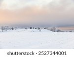 Rolling wintry landscape with snow and frost on a cold winter day