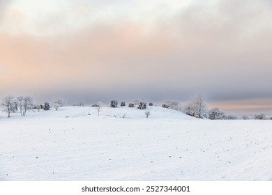 Rolling wintry landscape with snow and frost on a cold winter day - Powered by Shutterstock