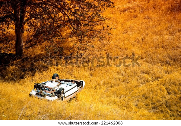 Rollover Compact Car\
Crash. White Crashed Car in the Mountain Road Ditch in California,\
USA. Traffic Accident.