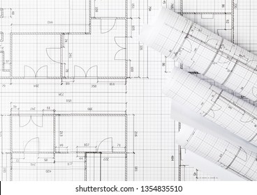 Rolls Of Architectural Blueprint House Building Plans On Blueprint Background On Table Flatlay Top View From Above