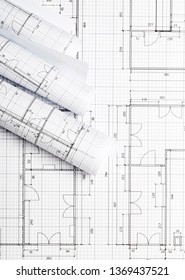 Rolls Of Architectural Blueprint House Building Plans On Blueprint Background On Table Flatlay Top View From Above