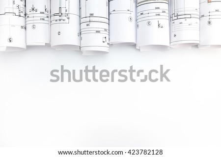 rolls of architecture blueprints and technical drawings on white background