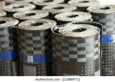 Rolls Of Bituminous Waterproofing Standing In A Warehouse