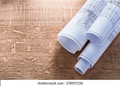Rolls of blueprints on wooden oaken board construction concept  - Shutterstock ID 278957234