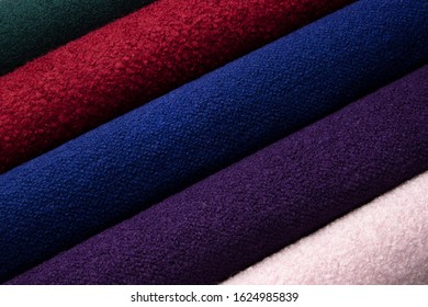 Rolls Of Cashmere Fabric Of Different Colors For Tailoring A Coat In A Factory.