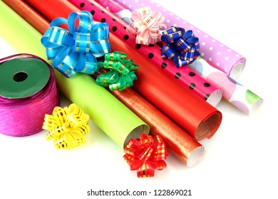 Rolls Of Christmas Wrapping Paper With Ribbons, Bows Isolated On White