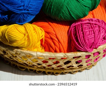 Rolls of colorful threads in a wicker basket. Colorful cotton cord. Crocheting and knitting is my favorite hobby. - Shutterstock ID 2396512419