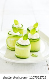 Rolls of cucumber with curd cheese and yogurt with mint. - Shutterstock ID 1107522725