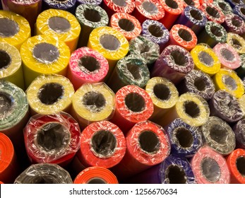 Rolls Of Decorative Wrapping Paper Of Different Colors Are On The Store Shelf