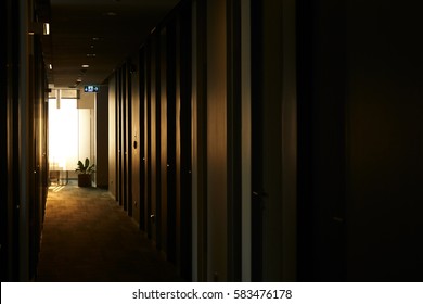 Rolls Of Empty Dark Office Hallway At Dawn