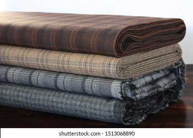 Rolls of fabric and textiles in atelier or store. Different fabric for business suit. Industrial fabrics. Closeup	
